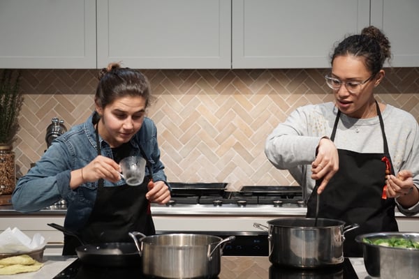 two people cooking