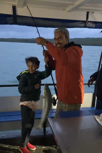 Debajeet and his son with a king fish