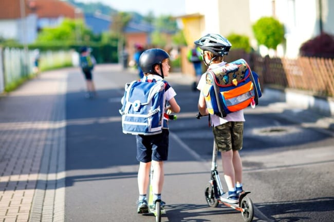 boys scootering to school