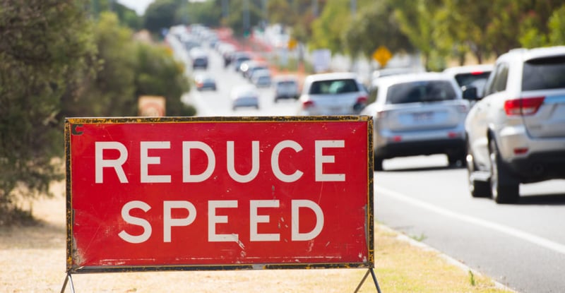 reduce speed sign