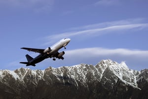 Plane taking off near mountains