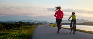 woman running child cycling